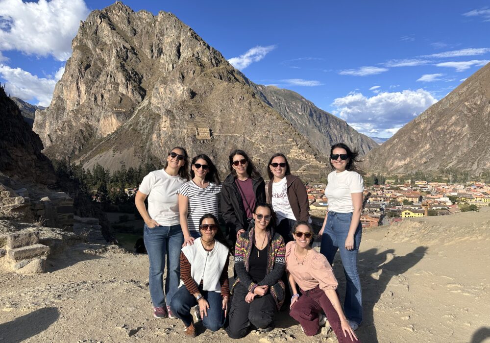 Travelers admiring the Pisac Inca terraces and hilltop fortress on a private Sacred Valley day tour from Cusco