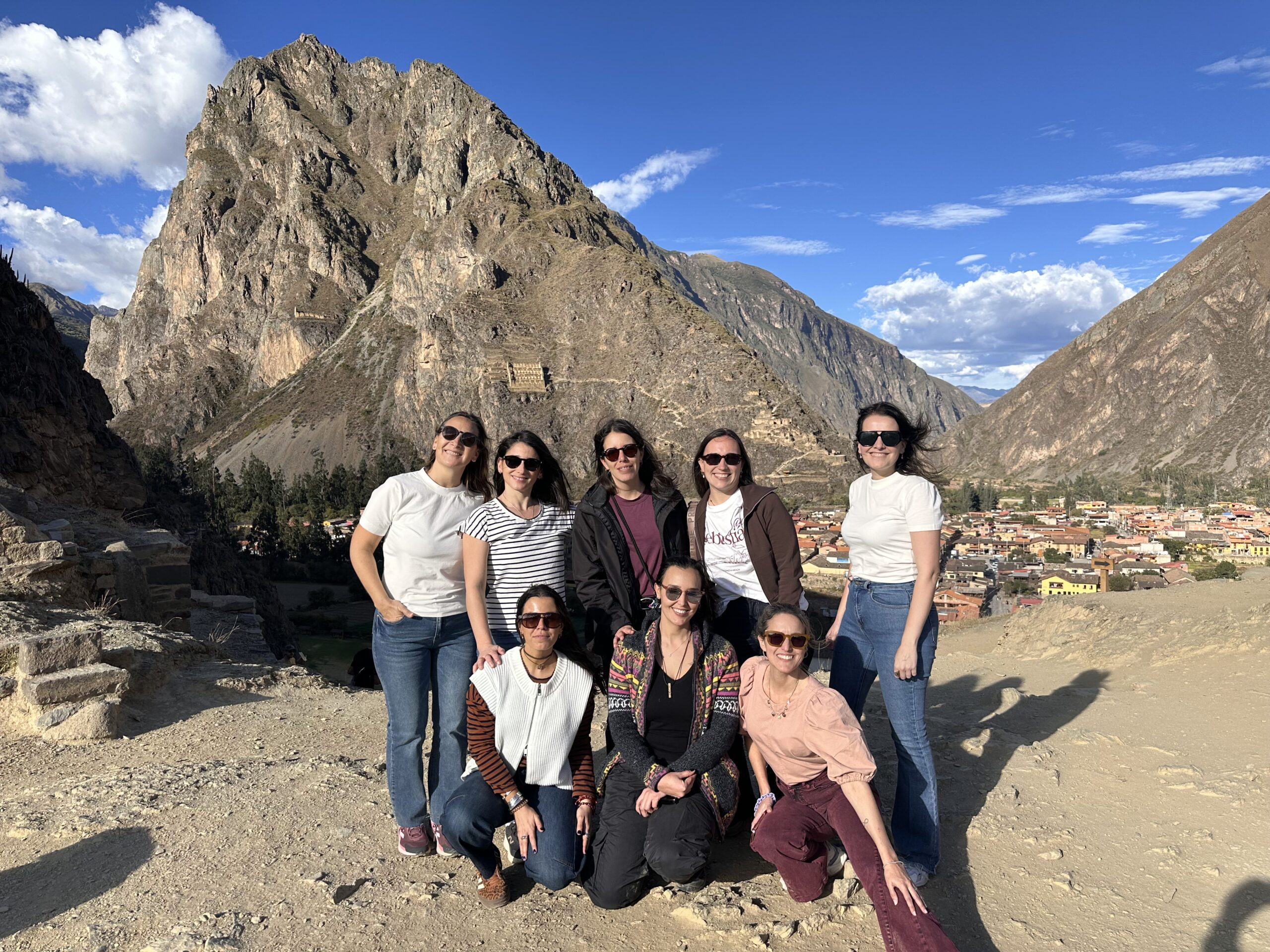 Travelers admiring the Pisac Inca terraces and hilltop fortress on a private Sacred Valley day tour from Cusco